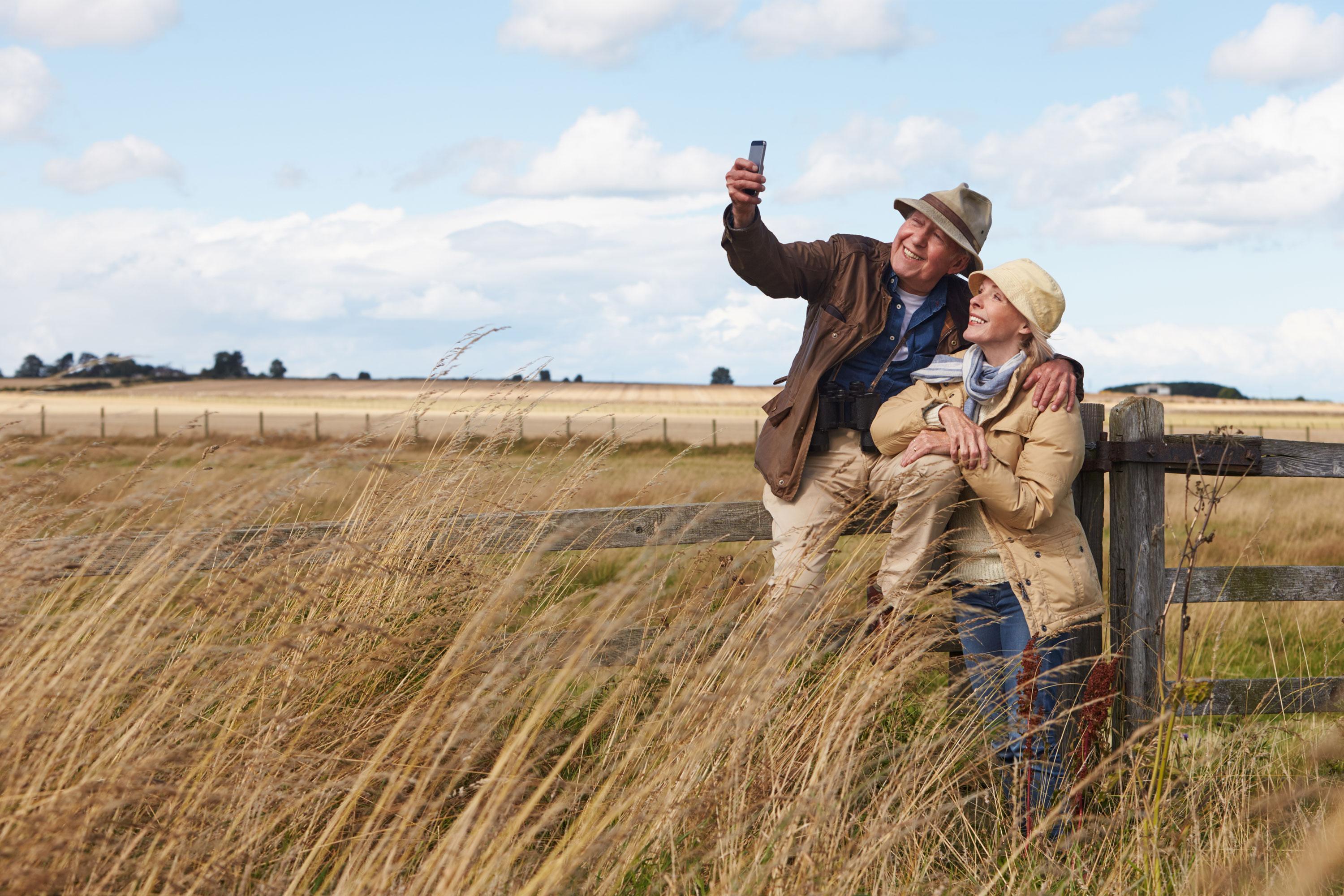 Couple taking a picture in a field 